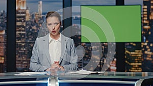 Presenter showing mockup screen reporting breaking news in tv channel studio