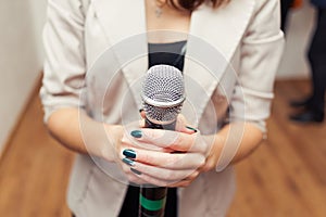 Presenter on stage with microphone. Wedding MC. Toastmaster.