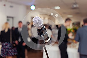 Presenter on stage with microphone. Wedding MC. Toastmaster.