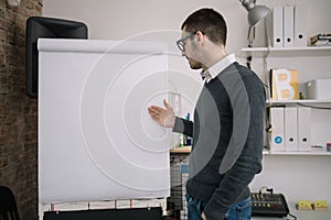 Presenter standing in front of a blank paper whiteboard