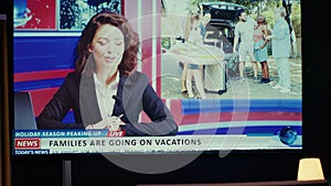 Presenter on TV screen showing reportage about summer vacations on VOD travelling channel