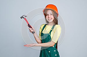 presenting product. engineer on grey background. laborer kid wear hardhat. labor day.