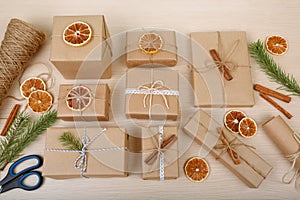 Presents collection laid on a wooden table with package accessories. New year preparation