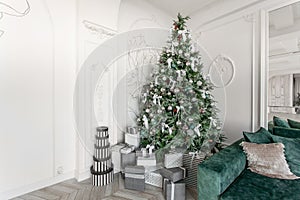 Presents and Gift boxes under Christmas Tree. Boxes with ribbon bow. New year decorated house interior. Winter Holiday
