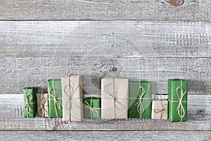 Presents in gift boxes on wooden frame background. Flat lay, top