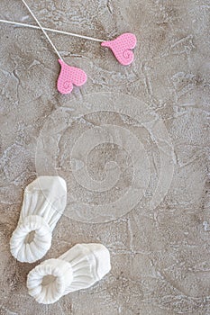 Presents set for baby shower with shoes gray stone background top view mockup