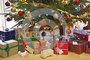 Presents under an illuminated christmas tree