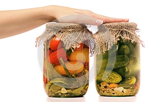 Preservation of a bank of cucumbers and a bank of tomatoes female hand