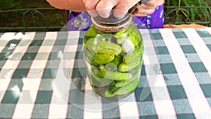 Preservation of cucumber vegetables in a glass jar.