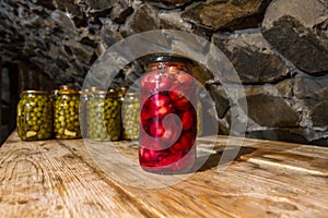 Preservation, pickles, marinades, in glass jars stand in the basement