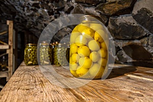 Preservation, pickles, marinades, in glass jars stand in the basement