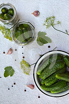 Preservation of pickling cucumber. Preparation of conservation from organic vegetables on a light background. Homemade organic cru