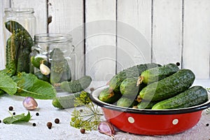 Preservation of pickling cucumber. Preparation of conservation from organic vegetables on a light background. Homemade organic cru