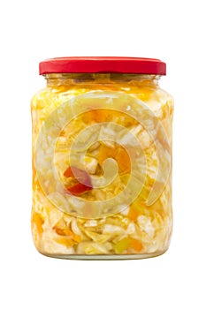 Preserved cabbage and red paprika salad in glass jar on a white background.