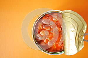 preserved canned tomato beans on color background