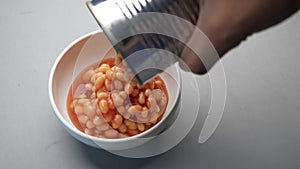 preserved canned tomato beans pouring into a bowl