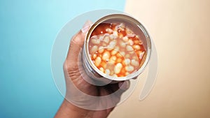 preserved canned tomato beans pouring into a bowl