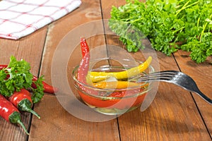 Preserved Pickled Chilli Peppers in Glass Bowl with Fork, Fresh