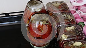 Preserved Sun Dried Tomatoes. Overturned jars of tomatoes are on the table. The camera moves on a slider. Close-up