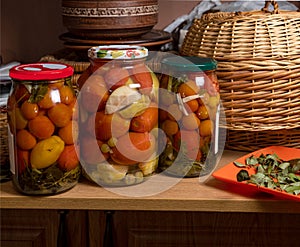 Preserved tomatoes in glass jar . Homemade pickled vegetables