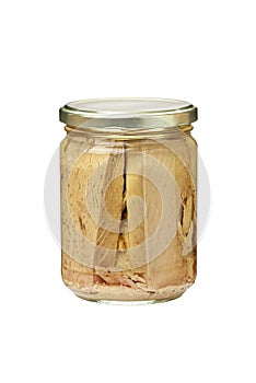Preserved tuna fish fillets in a glass jar. Isolated on white
