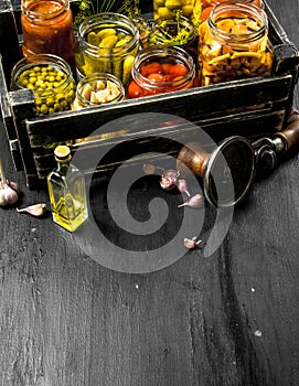 Preserved vegetables and mushrooms in a box with seamer.