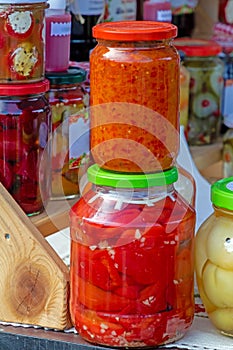 Preserved vegetables sold in jars on market photo