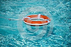 Preserver lifebuoy. Orange lifebuoy in sea on water. Life ring floating of water.