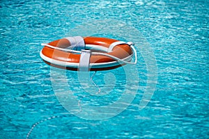 Preserver lifebuoy. Orange lifebuoy in sea on water. Life ring floating of water.