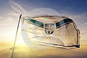 Presidente Hayes Department of Paraguay flag textile cloth fabric waving on the top sunrise mist fog