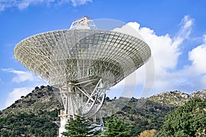 Presiding over the complex with a large antenna exploring deep space.