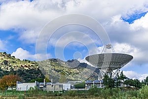 Presiding over the complex with a large antenna looking up exploring deep space.