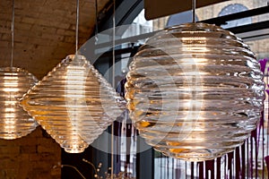 Press glass pendant lights at the Tom Dixon flagship store and showroom at Coal Drops Yard, Kings Cross, London UK