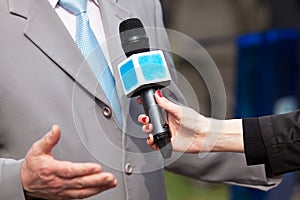 Press interview. Microphone. Journalism.