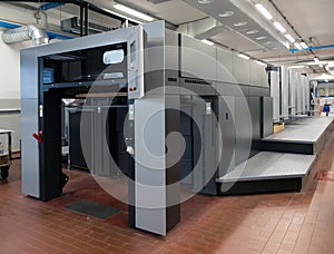 Press printing - Offset machine. Printing technique where the inked image is transferred from a plate to a rubber blanket, then to