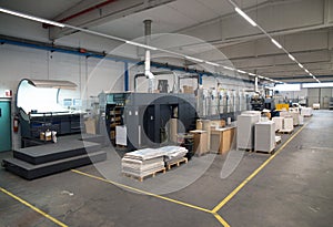 Press printing - Offset machine. Printing technique where the inked image is transferred from a plate to a rubber blanket, then to photo