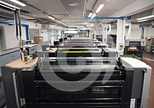 Press printing - Offset machine. Printing technique where the inked image is transferred from a plate to a rubber blanket, then to