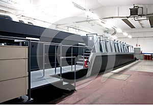 Press printing - Offset machine. Printing technique where the inked image is transferred from a plate to a rubber blanket, then to