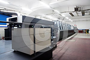 Press printing - Offset machine. Printing technique where the inked image is transferred from a plate to a rubber blanket, then to