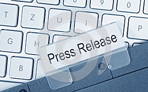 Press Release - folder with text on computer keyboard photo