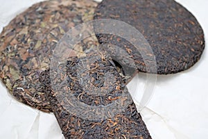 Pressed pancake and brick-shaped puer tea top view.