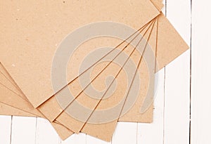 Pressed paper on wooden background