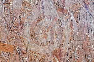 Pressed wood panel background, seamless texture oriented Board-OSB. close up