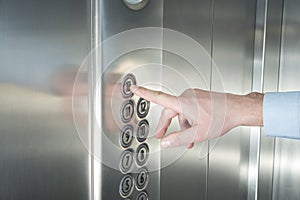 Pressing the button in the elevator