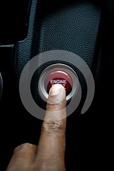 Pressing engine start stop button on the car.