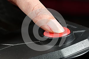 Pressing STOP or START button. Finger presses the red button.