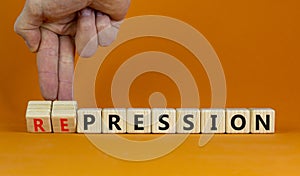 Pression to repression symbol. Businessman turns wooden cubes, changes the word pression to repression. Beautiful orange