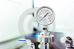 Pressure gauge on beer tank brewing equipment. Close-up, macro