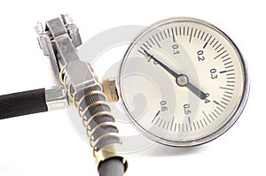 Pressure gauge for measuring air pressure in car tires on a white background