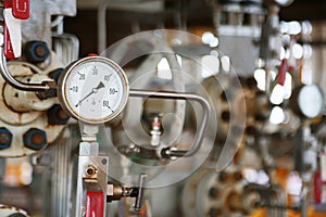Pressure gauge using measure the pressure in production process. Worker or Operator monitoring oil and gas process